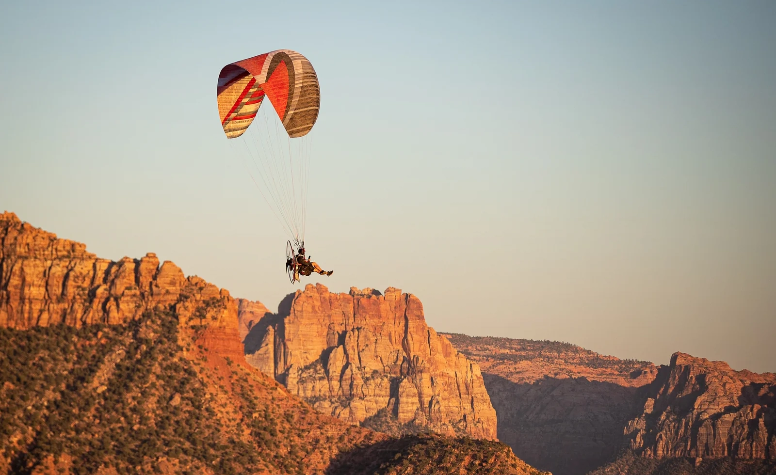 Paramotor flying over red rock terrain in Southern Utah
